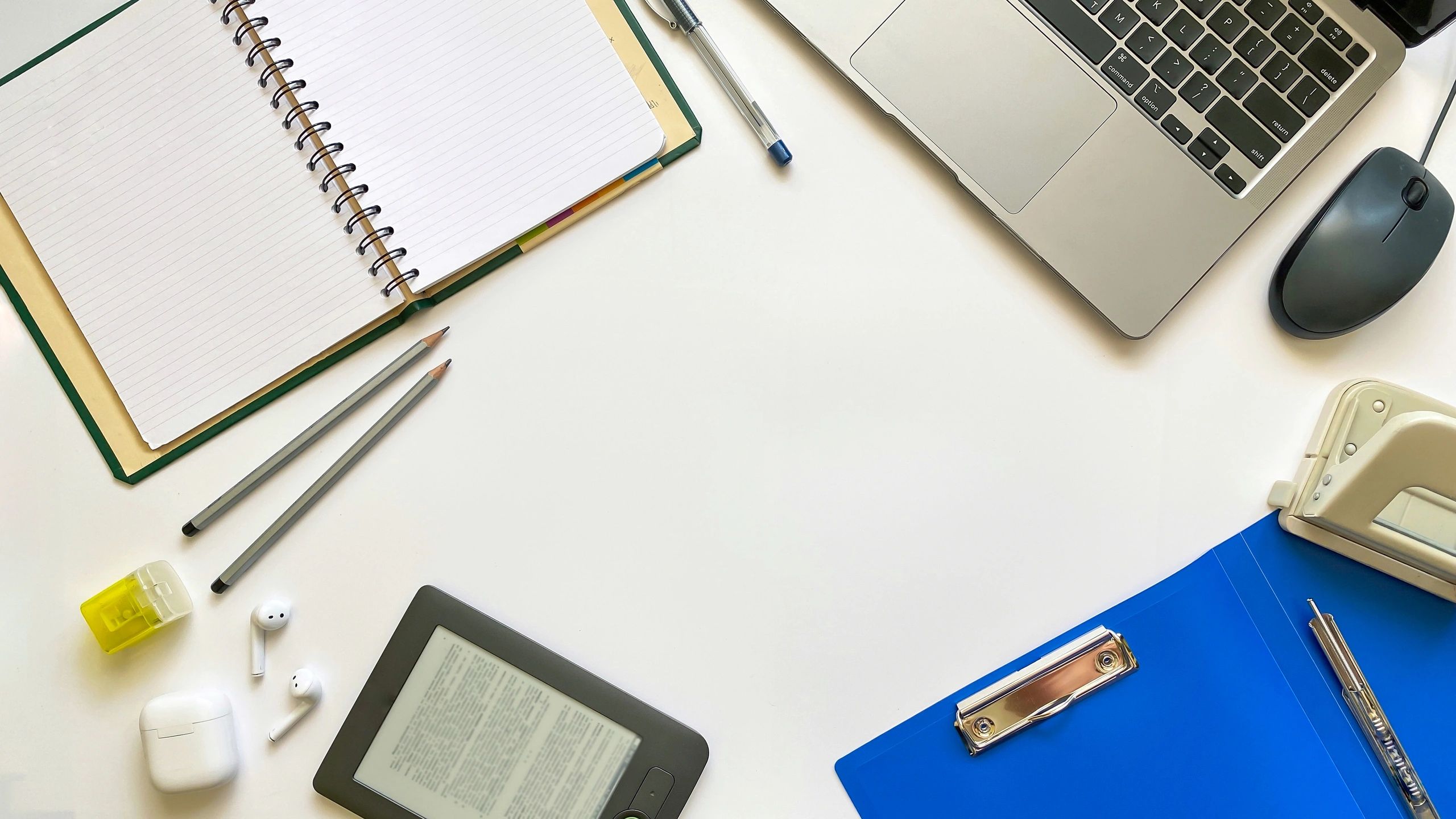 Editorial desk setup with laptop and notebook