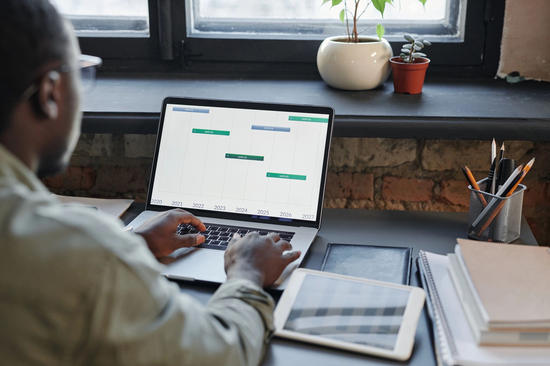 Person working at a desk with data on screen