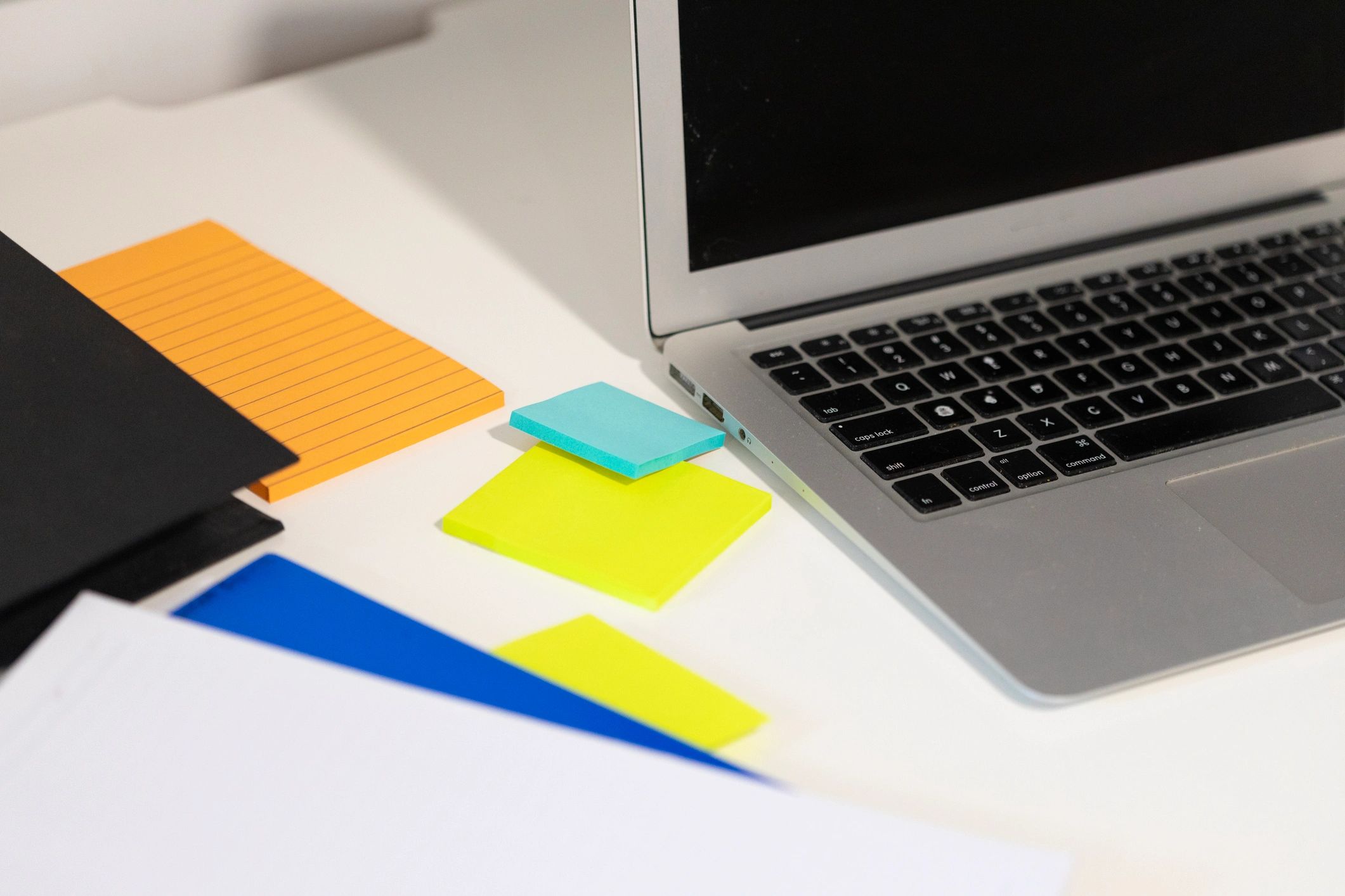 Laptop and sticky notes on a desk