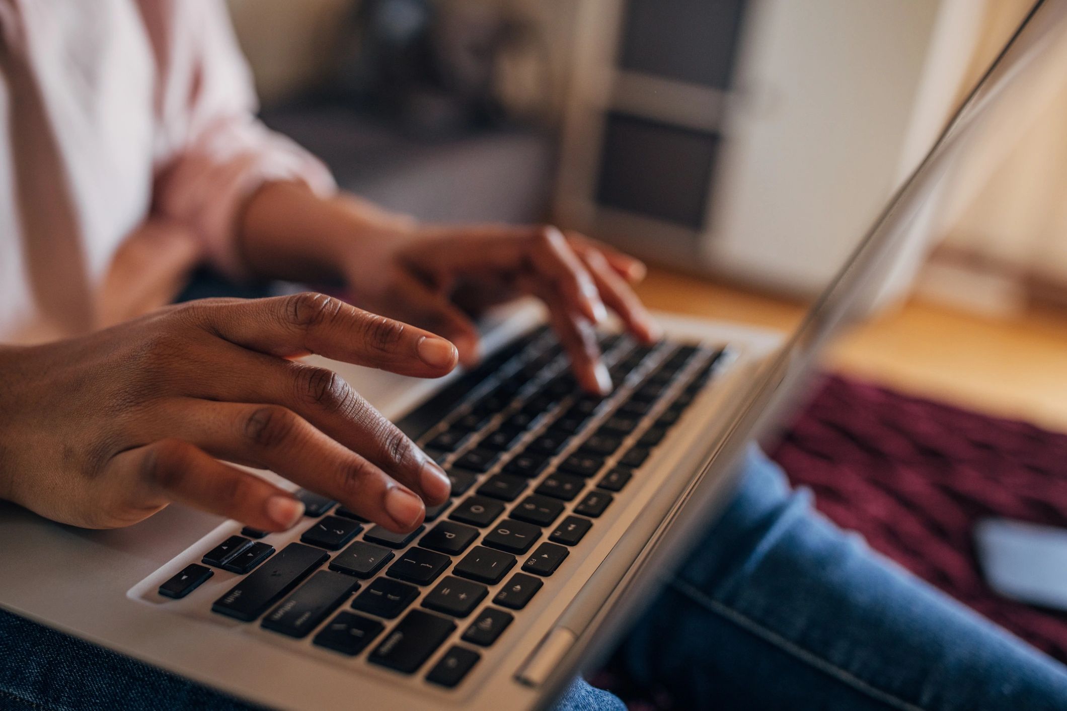Hands typing on a laptop keyboard during focused work