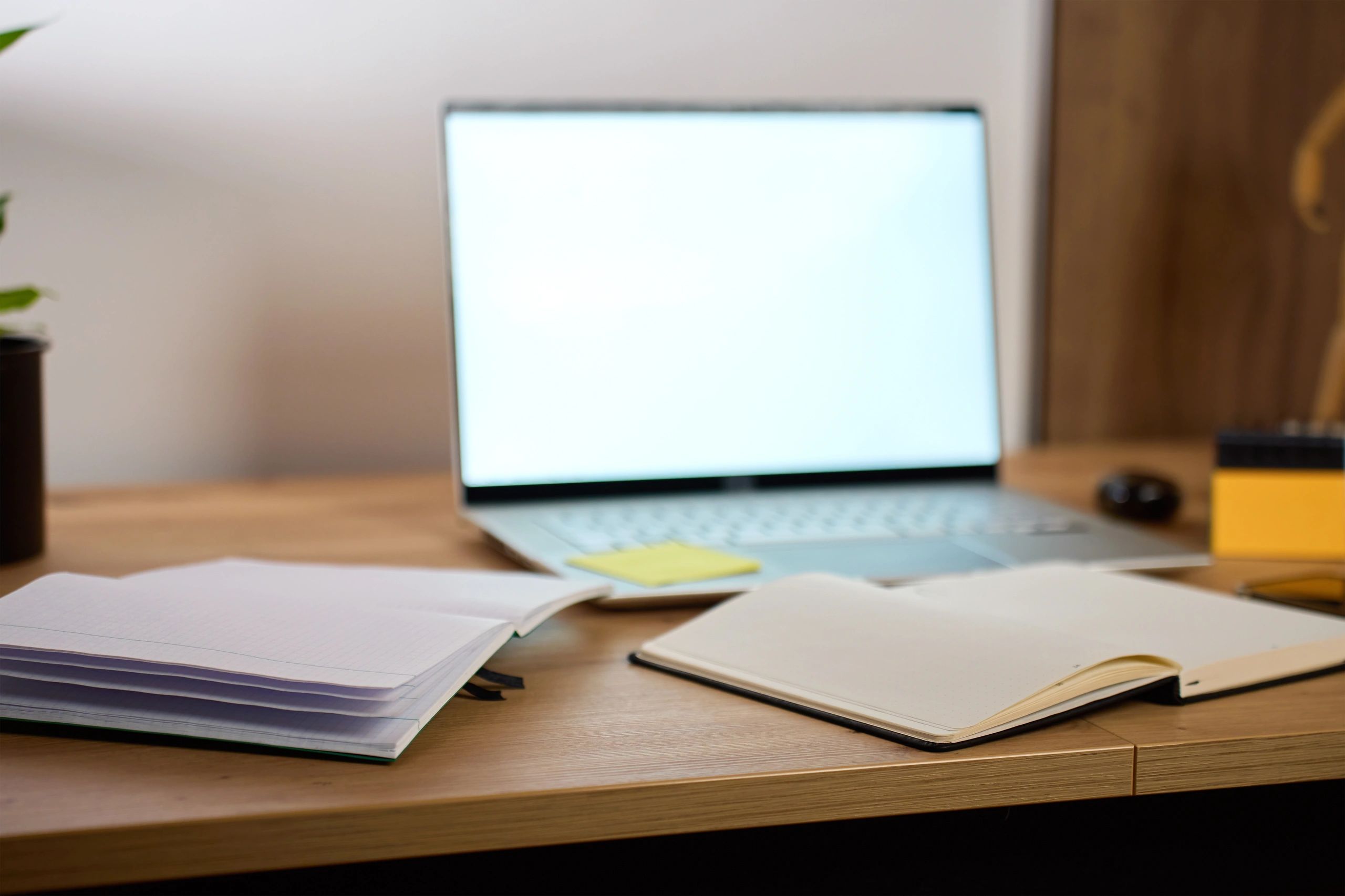 Notebook and laptop in a home workspace